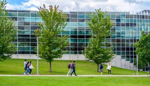 Students walking outside Administration Building during the spring season